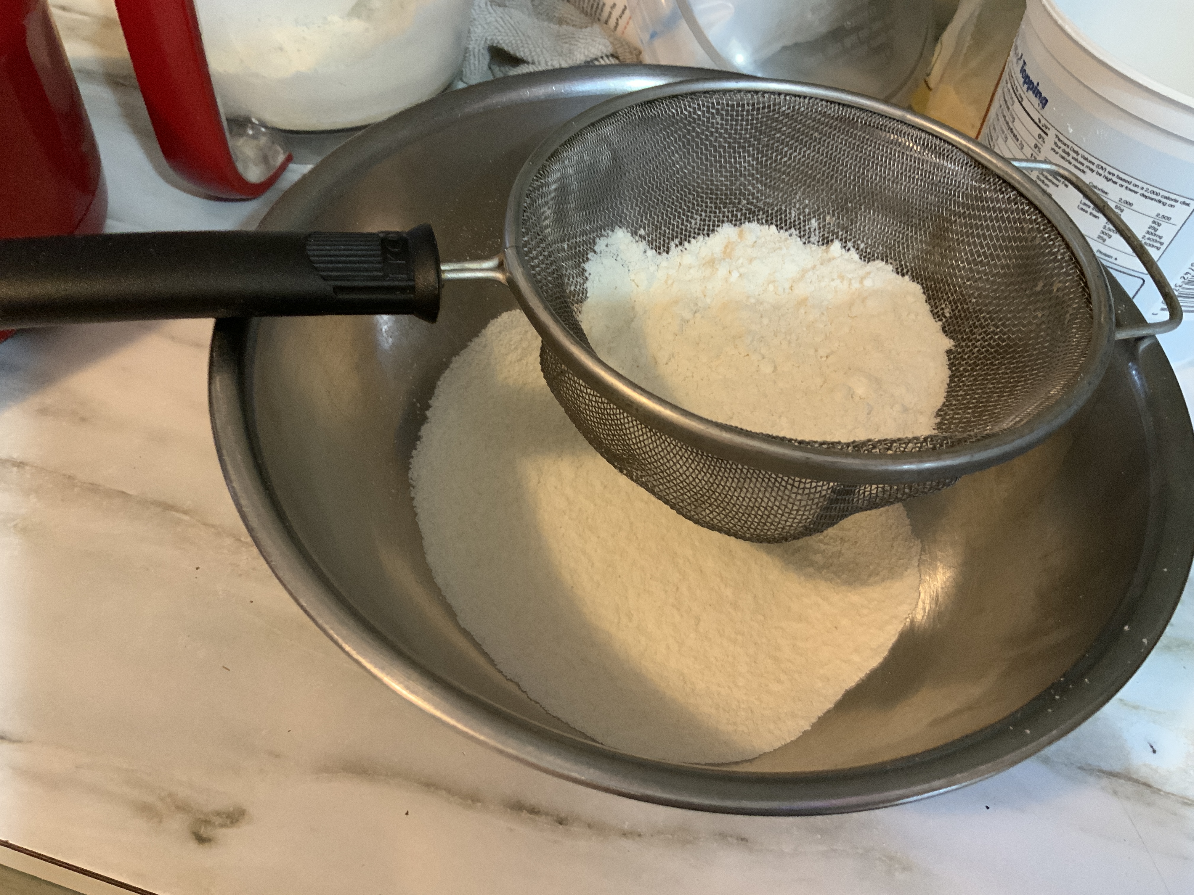 “Sifted almond flour and powdered sugar”